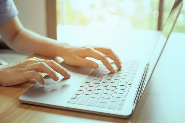 istock closeup man hand using laptop on desk office place 1329665199