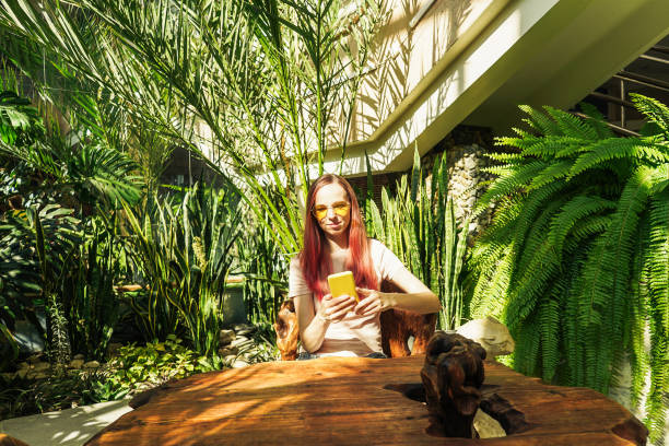 istock Woman working on phone on terrace cafe. 1329666673