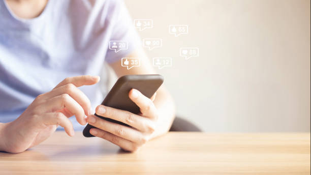 istock email marketing concept, closeup hand using smart phone with email icon 1329666684