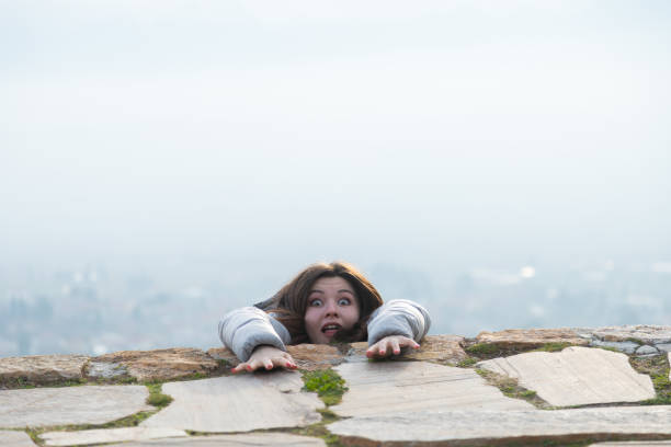 Young woman falling off from a mountain hill