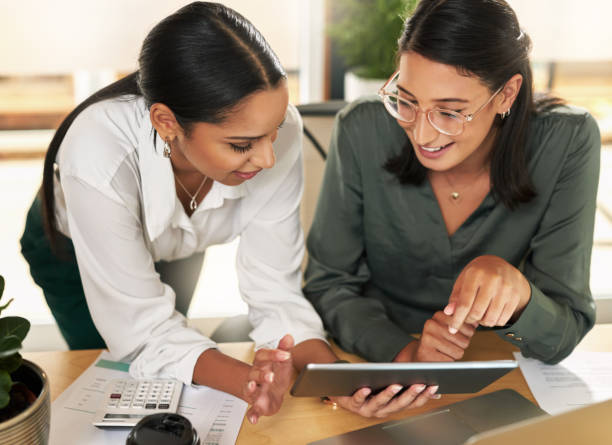 istock Shot of two businesswomen using a digital tablet to oversee work 1329668205