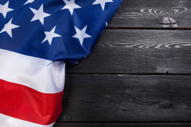 istock USA flag on dark wooden table background 1329668991