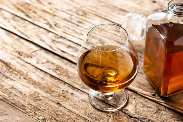 istock Cognac drink on wooden table 1329671340