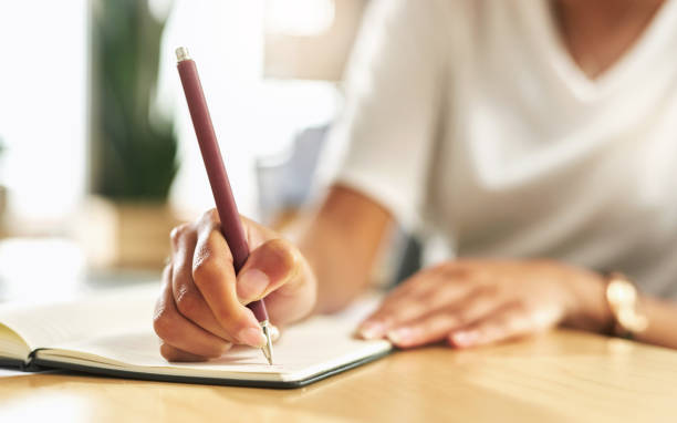 istock Shot of a businesswoman making notes in her notebook 1329672624