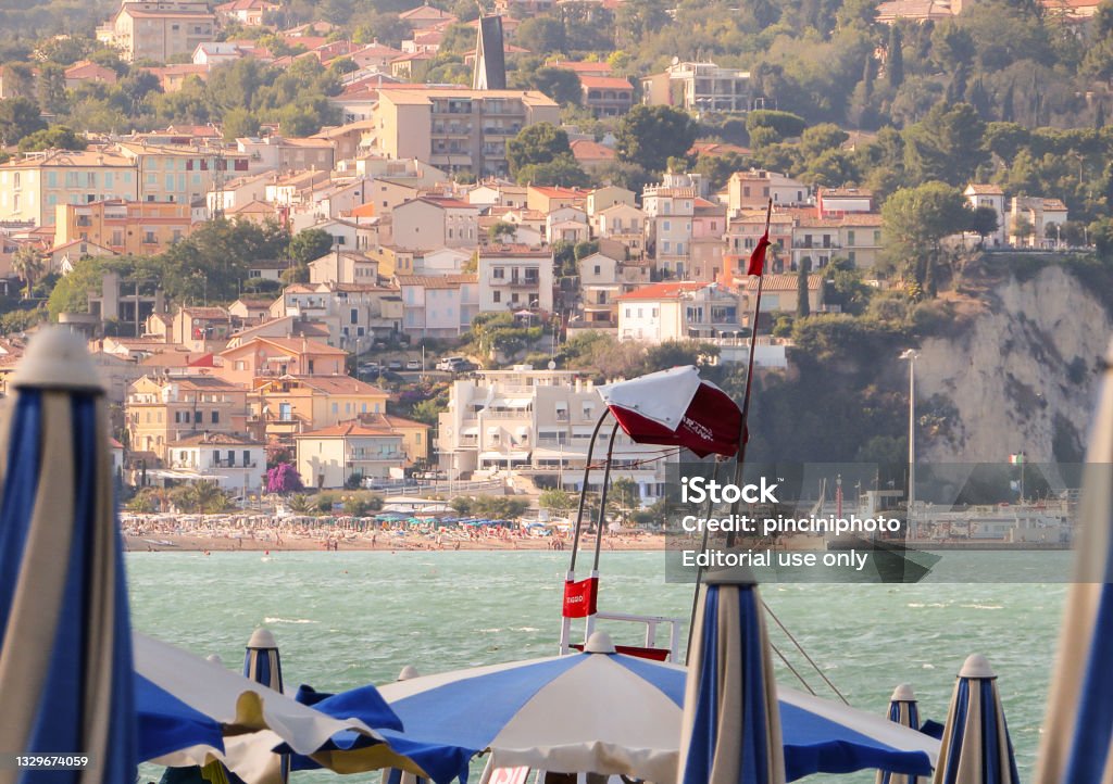 Numana beach (Italy) Numana, Italy - July 18, 2021: View of Numana Beach (Italy) with lifeguard station and umbrellas. Numana is an Italian town in the province of Ancona in the Marche region, located in the Conero Riviera. Numana Stock Photo