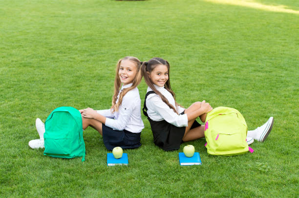 istock School friends relaxing after classes at school yard, good team concept 1329677327