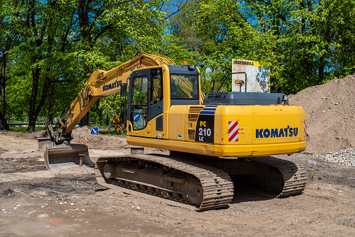 Põltsamaa, Estonia - May 30 2021: Excavator working on a construction site. Road works in Poltsamaa city. Selective focus.