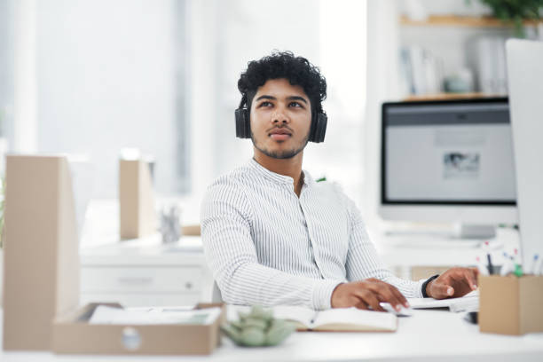 istock Shot of a young businessman looking thoughtful while working on a computer in an office 1329679304