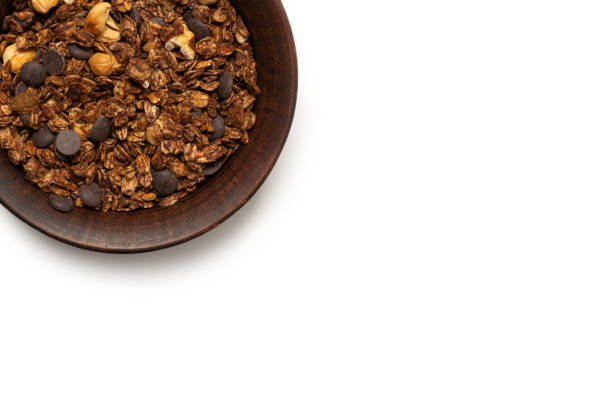 istock Chocolate granola cereal with nuts in a bowl background. 1329681814
