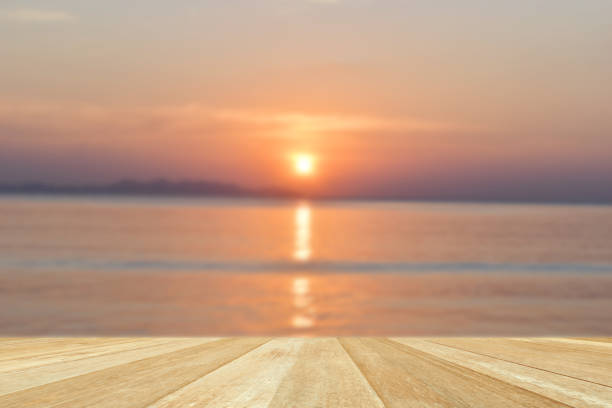 istock Empty top wooden table on blurred sunset at sea 1329682567