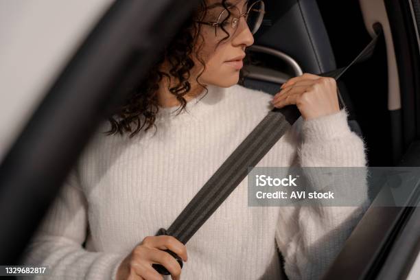 European Girl Buckles Down Seat Belt In Car Stock Photo - Download Image Now - Seat Belt, Belt, Safety