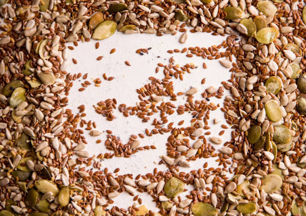 istock Frame from roasted seeds of different types on a white background. Copy space 1329683252