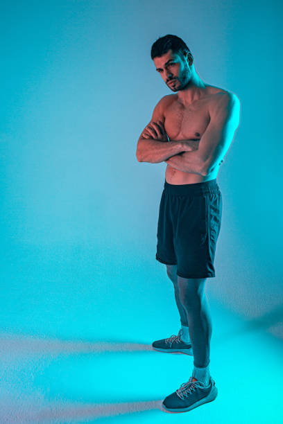 istock Confident european athletic man with crossed arms 1329683408