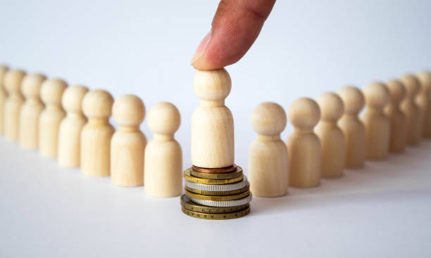istock Small group of separated people seen from above represented anonymous with wooden figures on white background. 1329685576