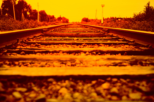 Railway going into the distance. Sunset background.