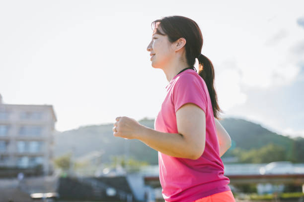 istock Woman enjoy running in the beach 1329687002