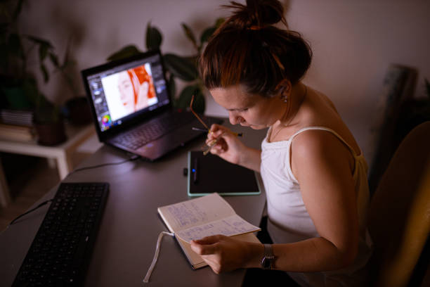 istock Dedicated female digital art student, learning new illustration techniques, late at night from her home office 1329687112