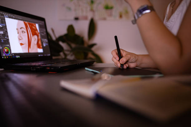 istock Curious female digital art student, learning new illustration techniques, late at night from her home office 1329687174