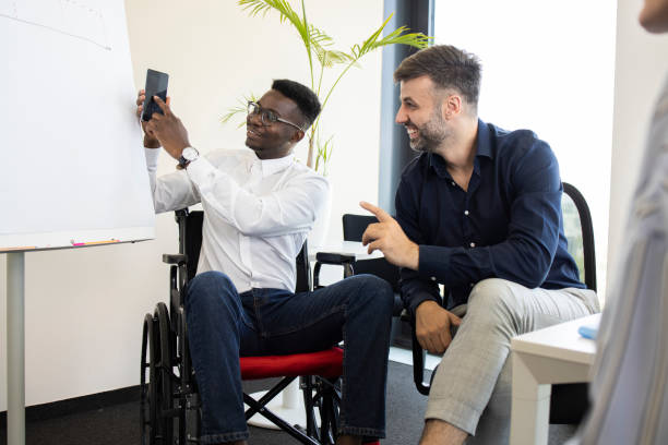 istock African American manager with disability showing a business plan to his team 1329689893