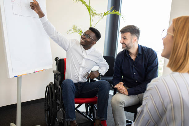 istock African American manager with disability and his team making a business plan 1329689910