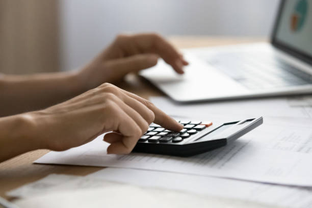 istock Close up successful business lady calculating online project expenditures. 1329690263