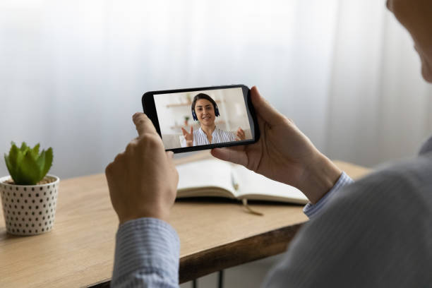 istock Young woman holding mobile phone video call conversation. 1329690272