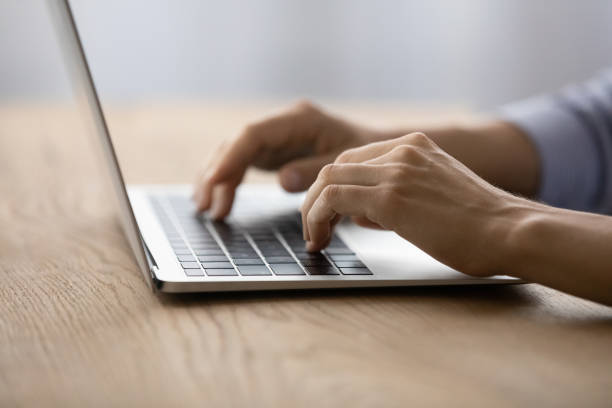 istock Close up young woman typing on laptop keyboard. 1329690273