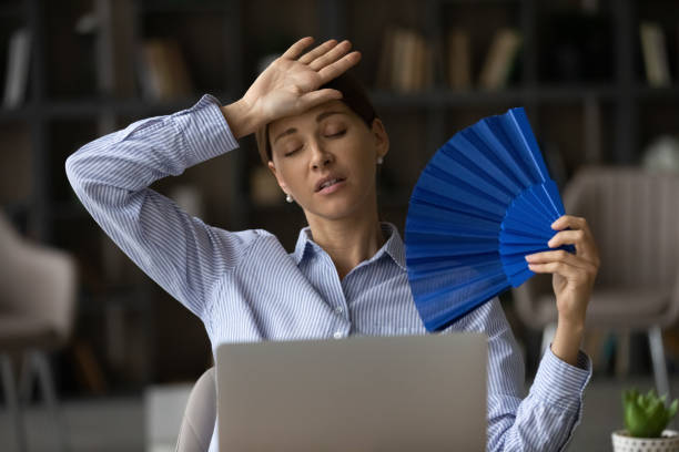 istock Frustrated unhappy young woman using paper fan. 1329690281