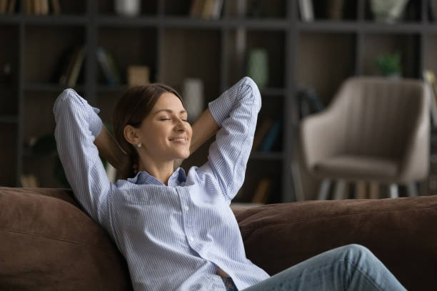 istock Relaxed happy young beautiful woman sleeping on comfortable sofa. 1329690293