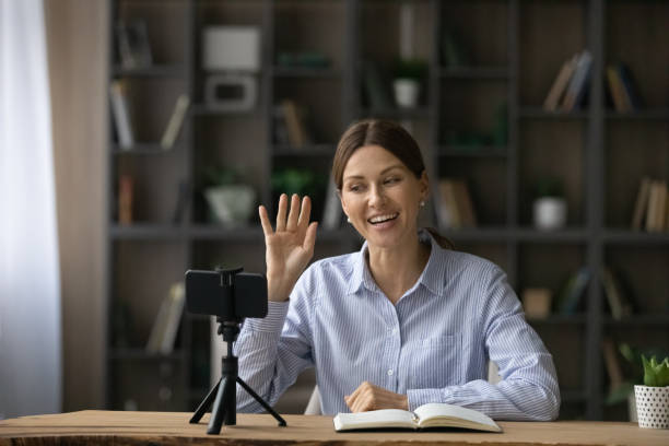 istock Smiling attractive young woman recording educational video. 1329690591