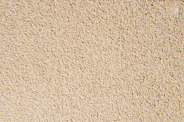 istock The surface of rough decorative sand-colored plaster 1329690699