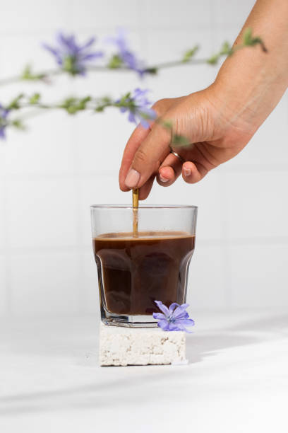 istock Chicory drink in a transparent mug with chicory flowers in the foreground. 1329691431