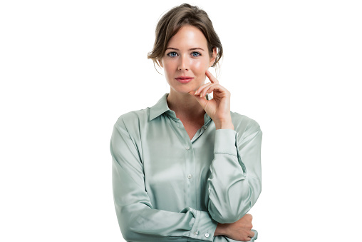 Studio portrait of attractive business woman standing at isolated white background. Copy space.