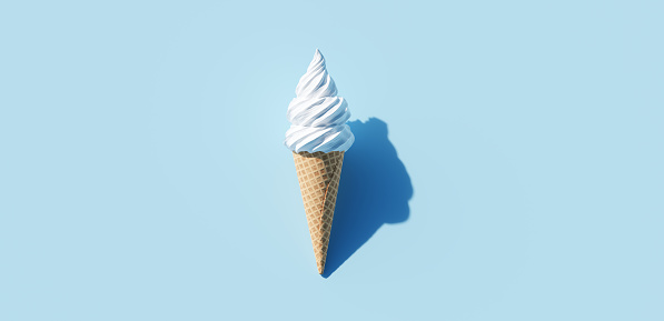 Soft serve ice cream in a cone on blue background