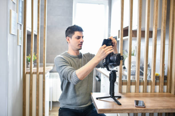 istock Modern Male Photographer Setting Up His Camera For Session 1329694241