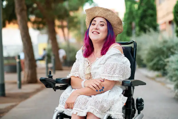 Photo of portrait of adult woman with disabiliites looking at camera