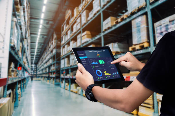 Smart warehouse management system. Worker hands holding tablet on blurred warehouse as background computor control stock pictures, royalty-free photos & images