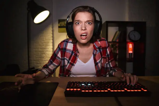 Photo of Nervous angry young woman gamer playing