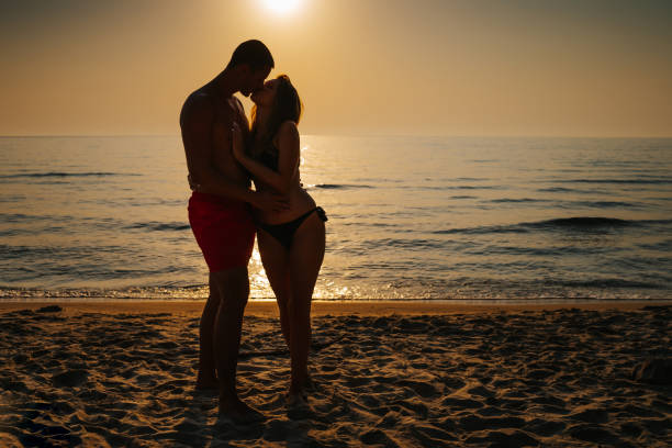 istock Young couple sharing love on summer vacation 1329697960
