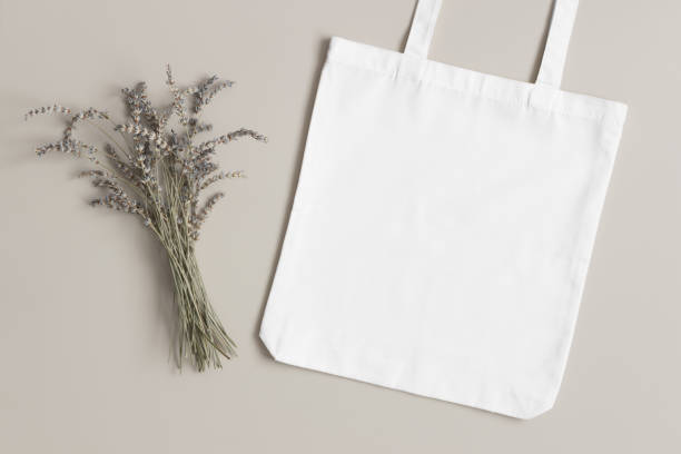 istock White tote bag mockup with a lavender decoration on the beige background. 1329698202