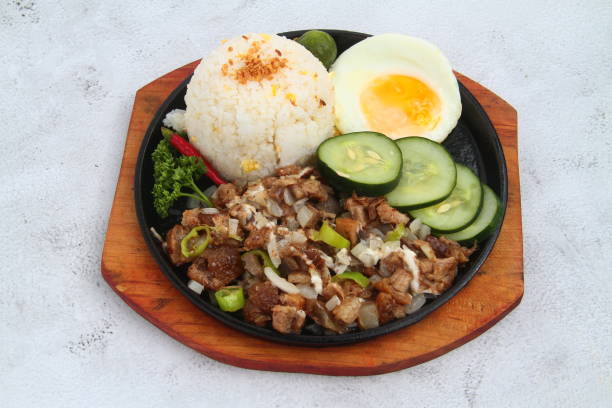 Freshly cooked Filipino food called pork sisig stock photo