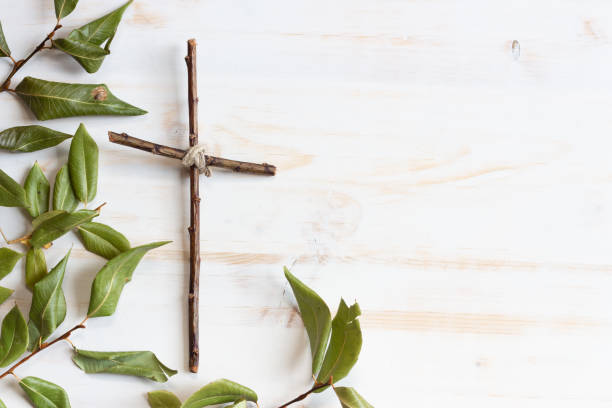 istock Wood cross with green leaves 1329701827