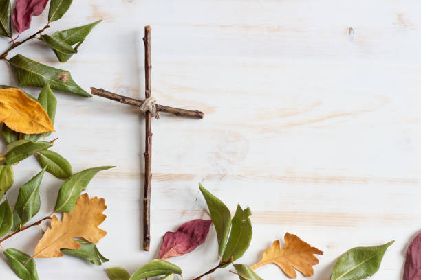 istock Wood cross with autumn leaves 1329701859