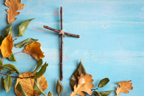istock Wood cross and leaves on blue 1329701871