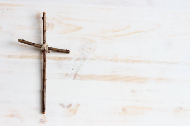 istock simple wood cross on white 1329701925