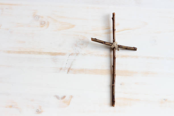 istock simple wood cross on right side of white background 1329701926