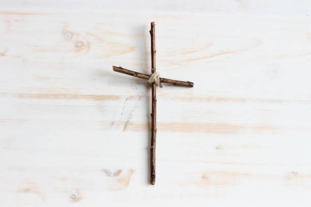 istock Simple wood cross centred on white 1329701932