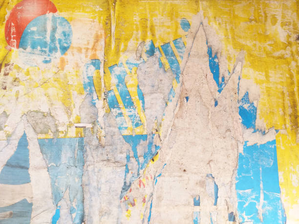 istock Old blue, yellow and white concrete facade deteriorated. Abstract wall background with uncorked paint in vivid colors. Old grunge moldy stained paper on the wall. Cubist style texture and patterns. 1329702296
