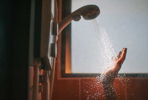 morning beginning of the day backlit sunlight bathroom asian chinese female washing her hand with running water