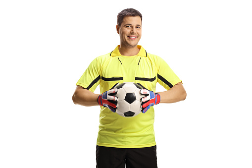 Goalkeeper holding a ball and smiling isolated on white background